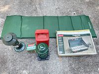 Overview showing sleeping pad, lantern with carry case, QuickPump box, and boxed stove