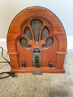 Front view of Crosley CR32 tabletop radio showing arched wood cabinet and controls