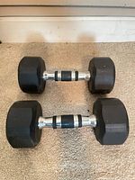 Two hex dumbbells side by side showing heads and handles
