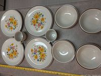 Overview of entire 15-piece set showing plates, bowls, mugs