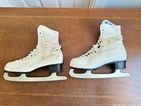 Both skates side view showing uppers, laces, blades, heel