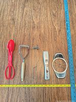 All five utensils laid out with measuring tapes for scale