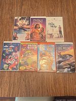 Front covers of seven tapes laid out on tabletop