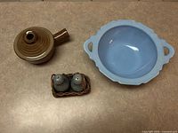 group shot of all items: blue bowl, brown sauce pot, salt & pepper shakers in wicker basket