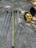 Six rods laid out beside tape measure, tackle box to right
