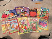 All books, crayons and watercolor set laid out on carpet