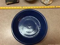 Top view of dark blue ceramic bowl showing interior glaze and scale