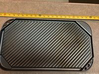 Full view of ridged grill surface with measuring tape showing length
