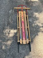 Full top view of sled showing overall condition, graphics, runners, steering bar and rope