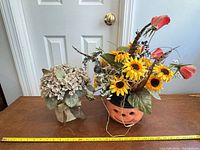 Both artificial arrangements side by side with tape measure for scale