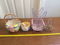 Group view of all four baskets with measuring tape for scale