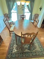 Dining table with six chairs on area rug