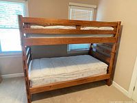 Front view of assembled solid wood twin bunk bed with mattresses