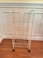 front angled view showing three shelves, handles and casters