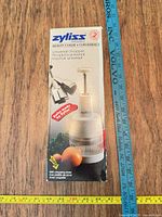 Front of boxed Zyliss universal chopper with measurable scale