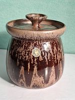 Front view showing body shape, drip glaze, foil label