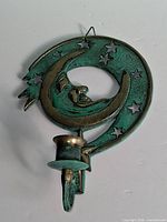 Front view of brass moon & stars wall sconce candle holder
