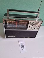 Front view of Candle TK-1849 radio showing dial, controls, speaker grille, carry handle