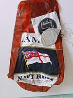 Folded inflatable showing Lamb's Navy Rum graphics and accessories