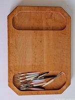 Top view of maple board showing recessed wells and forks arranged