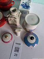 Overview showing cocottes, floral bottle, stopper, Delft shaker, Noritake jar base