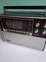 Front angled view showing full radio, dial, buttons, speaker grille