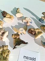 Overview of several figurines underside showing Wade marks and glazing