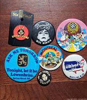 Front view of all seven pins arranged on wooden surface