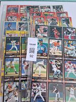 Stack of binder pages with assorted baseball cards (front view)