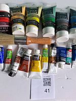 Front view of all paint tubes and brush laid out