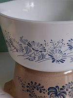 Close-up of white Colonial Mist bowl showing blue daisy pattern