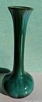 Full view of tall green-teal glazed vase