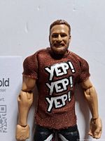 Front view of figure wearing brown YEP! shirt
