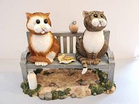 Front view showing full figurine with cats, bird, milk bottle, sandwich, and dimensions perspective