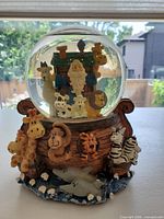 Front view showing animal figures on ark base and inside globe