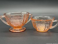 Both pink depression glass pieces side by side
