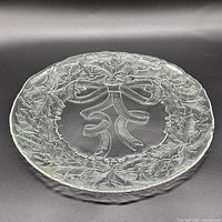 Full view of clear glass platter with holly wreath design