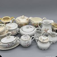Group shot of all porcelain pieces showing variety and floral patterns
