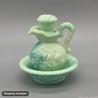 Front view of pitcher with stopper seated in bowl showing color and rose relief details