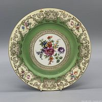 Front view of floral porcelain plate showing full design and gilded rim