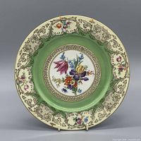 Front view of Bavaria Tirschenreuth 11 in porcelain plate showing floral center, green band, cream rim, gold gilt