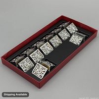 Set of eight silver-plated holders in original tray