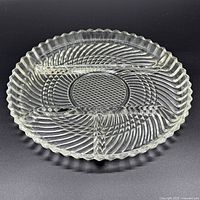 top view of clear pressed glass round relish dish showing three compartments and swirl pattern