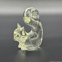Side view of clear glass squirrel figurine showing overall shape and tail curl
