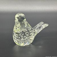 overall view of clear glass bird figurine showing form and internal bubbles