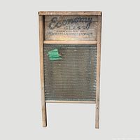 Full frontal view of the Economy Glass washboard showing wooden frame, glass ribs and printed branding