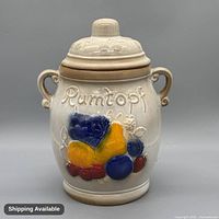 Front view of Rumtopf crock showing embossed hand-painted fruit design and lid