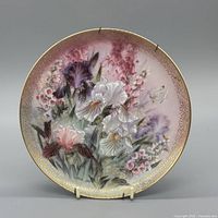 Front view of floral porcelain plate showing full artwork and gold rim
