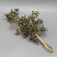 Entire artificial spray showing tan stem, branching arms with green leaves and pink beads
