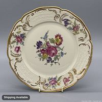 Front view of Rosenthal porcelain dinner plate showing floral decoration, relief border and gilt rim
